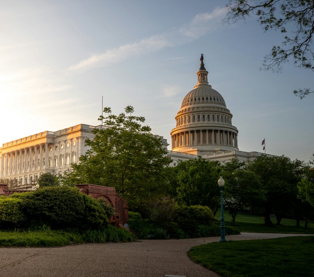The U.S. Capitol at sunrise, seen across its grounds